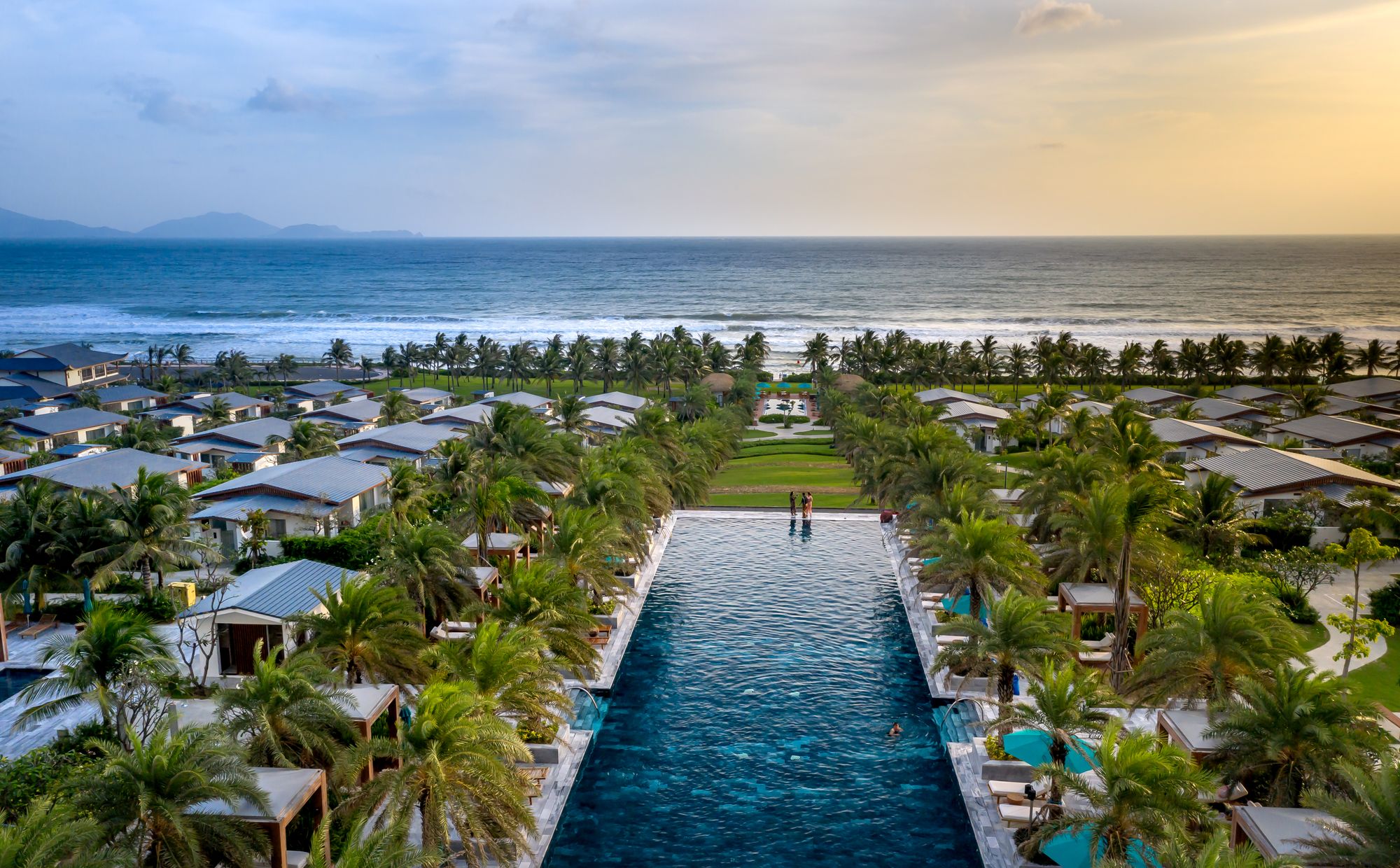 An oceanfront resort with an infinity pool, palm gardens and elegant villas